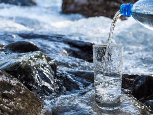 Water pouring into a glass from bottle